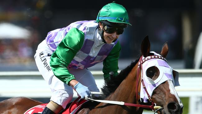 MELBOURNE, AUSTRALIA - NOVEMBER 03: Michelle Payne riding Prince Of Penzance smiles as she rounds the bend after winning race 7 the Emirates Melbourne Cup on Melbourne Cup Day at Flemington Racecourse on November 3, 2015 in Melbourne, Australia. (Photo by Scott Barbour/Getty Images)