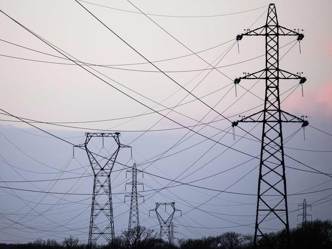 (FILES) This photograph taken on January 2, 2023 shows high voltage power lines in Cordemais, western France. - The electricity tariff shield, put in place by the French government since October 2021 to limit bill increases, will be maintained for another two years,  Minister of Economy Bruno Le Maire announced on April 21, 2023, on LCI. (Photo by LOIC VENANCE / AFP)