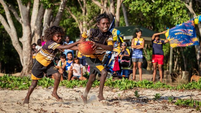 Members of the extended Rioli family play footy at Pirlangimpi in the Tiwi Islands. Picture: Amos Aikman