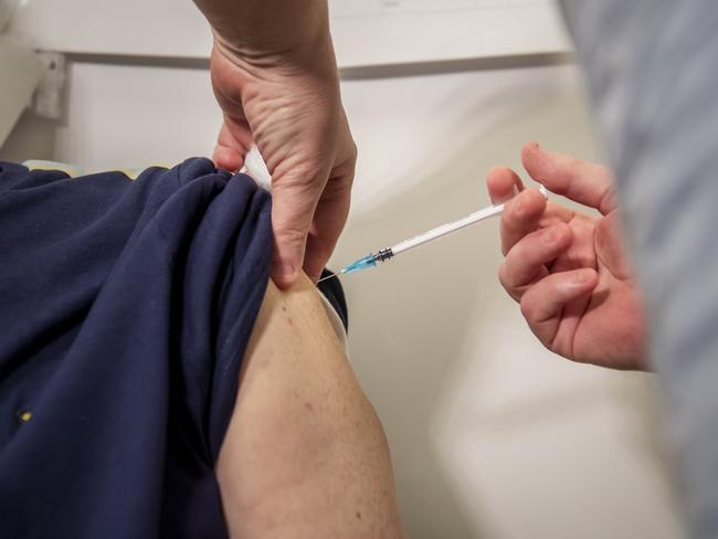 A man receives the Pfizer vaccine at a vaccination centre in England where the spread of COVID-19 is rampant. (Photo by Anthony Devlin/Getty Images)