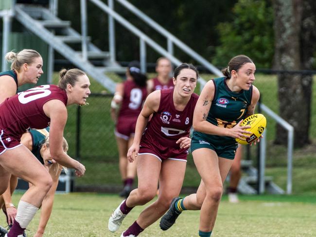 Tasmanian midfielder Perri King busts clear with the ball against Queensland at Bond University. Picture Aaron Black AFLQ Media.