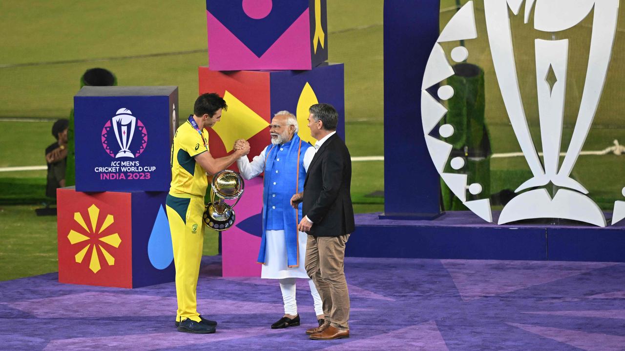 Cummins receives the trophy from India’s Prime Minister Narendra Modi. Picture: Money Sharma / AFP