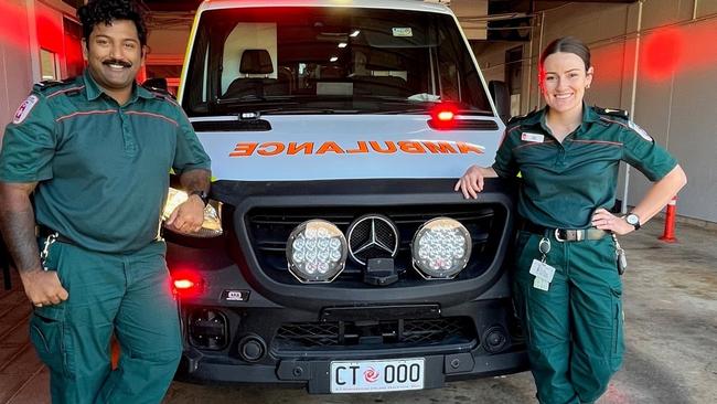 St John Northern Territory paramedics with the '000' commemorative Cyclone Tracy plate affixed to ambulance 74.