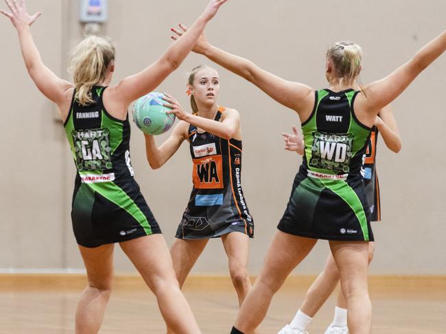 Sarah Joyce (centre) of Carina Tigers against Darling Downs Panthers in Queensland Ruby Series round eight netball at Downlands College, Saturday, June 3, 2023. Picture: Kevin Farmer