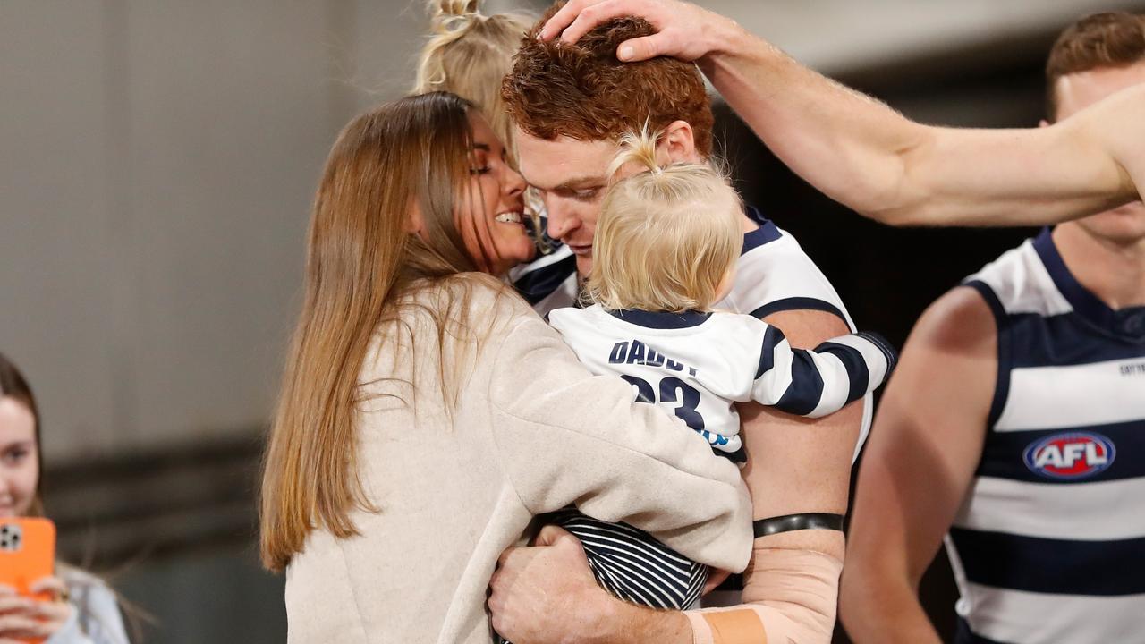 Gary Rohan of the Cats and his partner Madi Bennett embrace as he enters the field for his 150th match with his daughters Bella Ray and Sadie Rose.