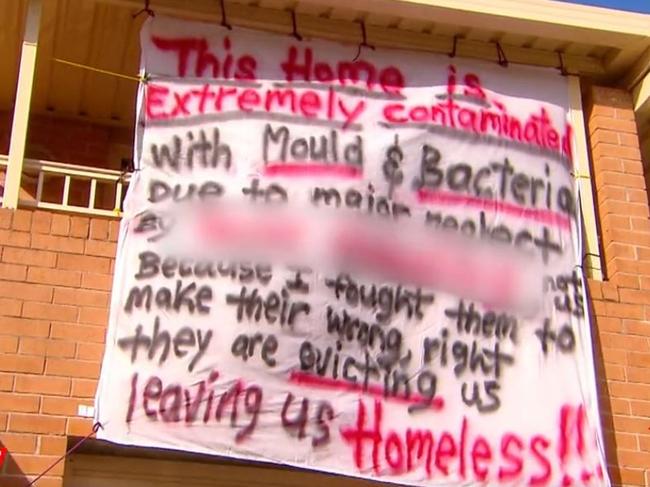 A banner has been erected on the home telling of Patsy and Madeline’s plight. Picture: ACA