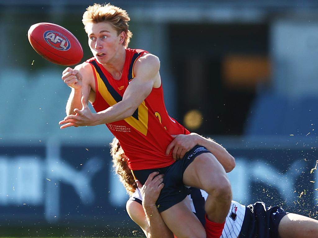 MELBOURNE, AUSTRALIA – JUNE 18: Sid Draper of South Australia handballs as he is tackled during the 2023 AFL National Championships match between Vic Country and South Asutralia at Ikon Park on June 18, 2023 in Melbourne, Australia. (Photo by Graham Denholm/AFL Photos via Getty Images)