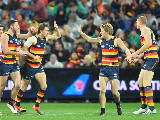 Crows players celebrate after kicking a goal during the Round 16 AFL match between the Adelaide Crows and the Western Bulldogs.