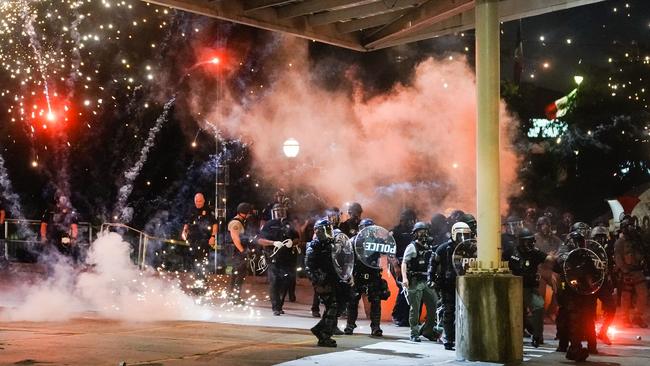 A firework explodes near a police line in Atlanta, Georgia.