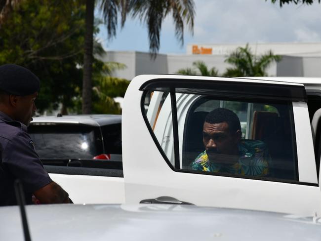 Ilaisa Tanoa Degei, 24, is escorted from a police vehicle to a holding cell at Nadi Magistrate’s Court on Monday.