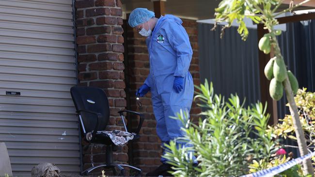 Forensics officers at the Stretton property where two people have been found dead. Picture: Nigel Hallett