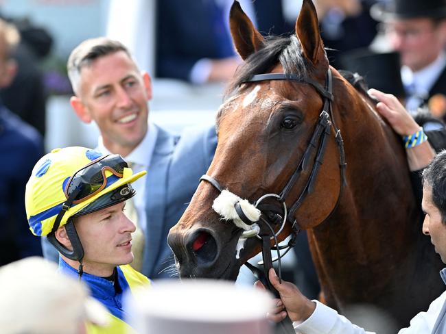 Jockey Richard Kingscote (L) in the winner's enclosure with Desert Crown after victory in the Derby. Picture: AFP