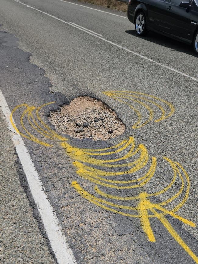 A pothole highlighted with spray paint to warn motorists. Photo: Supplied.