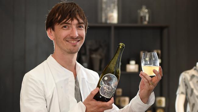 Part of the Hot 100 > Weekend . Jet guitarist Cameron Muncey decanting wine behind the bar at Tanner and teague, a design clothing store in Fitzroy. Picture: David Smith