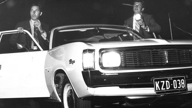 May 1972: Sergeant Bill Kneebone flashes a spotlight while on patrol as Senior Constable Bill Perkins calls headquarters. Picture: Herald Sun