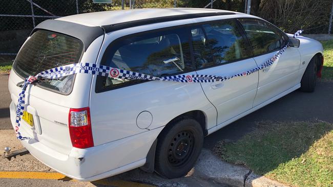 Police tape around a damaged Holden Commodore abandoned in Quirk Rd, Manly Vale. Picture: Jim O'Rourke