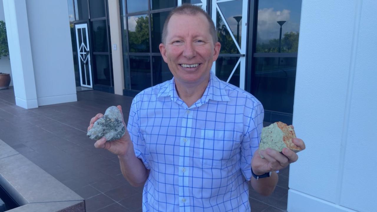 Ian Scrimgeour, senior executive director with the NT Geological Survey, with a lump of lithium (left) and rare earth.