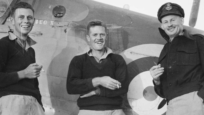 Western Desert. Flight Lieutenant John Jackson, at right, with two of his ground crew, leading aircraftman R. Dunning and J. Morvell. Picture: Australian War Memorial