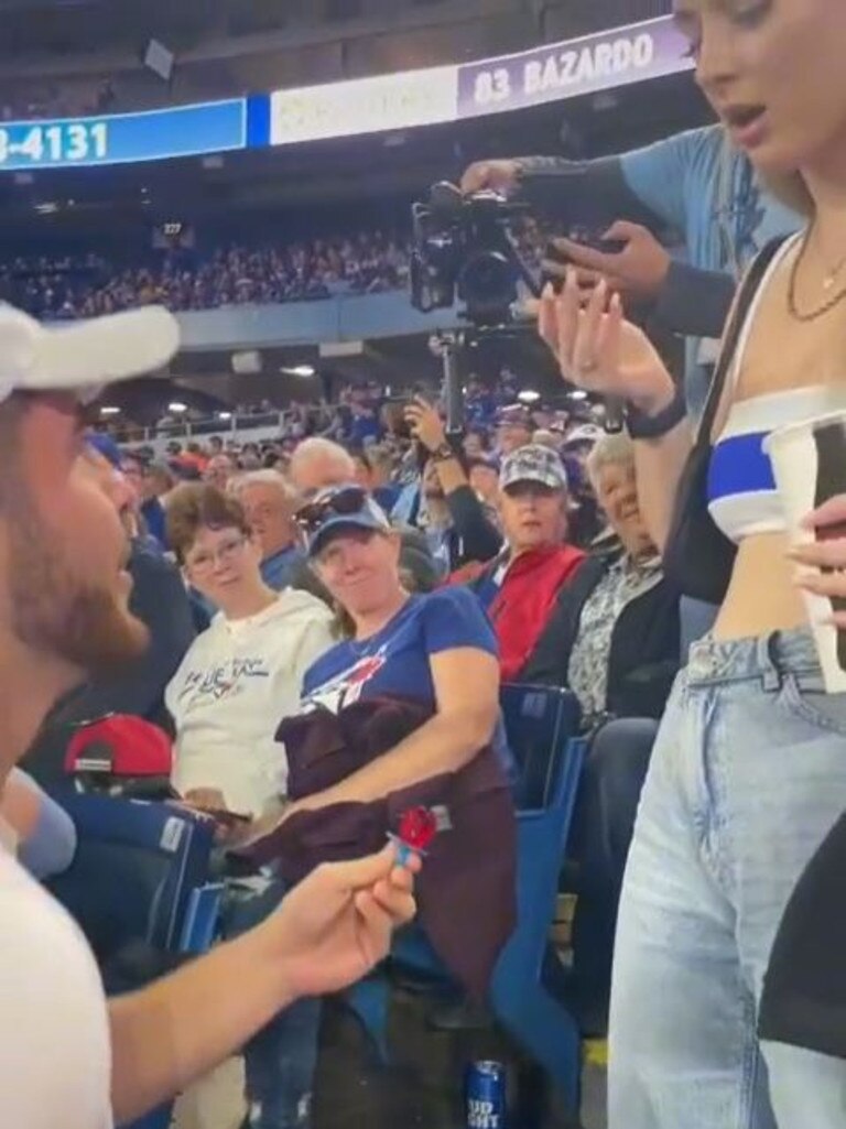 A furious girlfriend was left shocked after her boyfriend proposed to her with a Ring Pop at a Toronto and Boston Major League baseball game. Picture: TikTok / @canadianpartylife