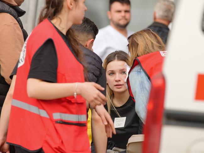 Family members surround one of the victims at the garden of Kocani General Hospital while her sister remains missing. Picture: Getty Images