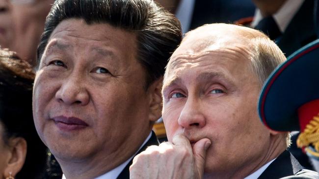 Vladimir Putin and Xi Jinping watch the Victory Day military parade at the Red Square in Moscow.