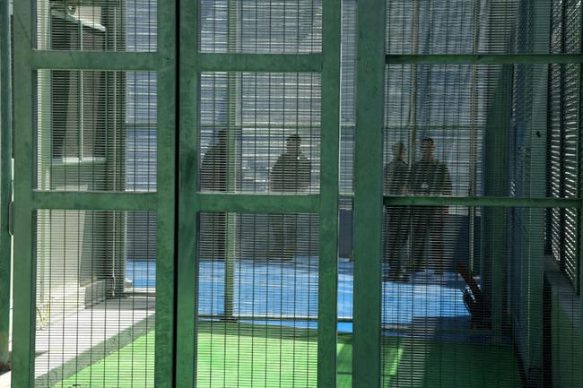 Italian police stand guard inside a recently built migrant processing centre in the Albanian port of Shengjin