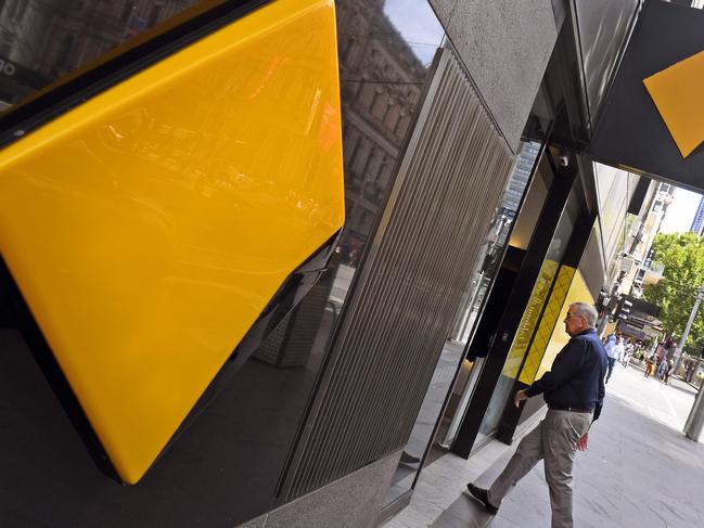 A man walks into a branch of the Commonwealth Bank in Melbourne on February 6, 2019. - Australia's largest financial firm Commonwealth Bank on February 6 said profits fell six percent in the last six months of 2018 amid a "challenging environment" for the business. (Photo by William WEST / AFP)