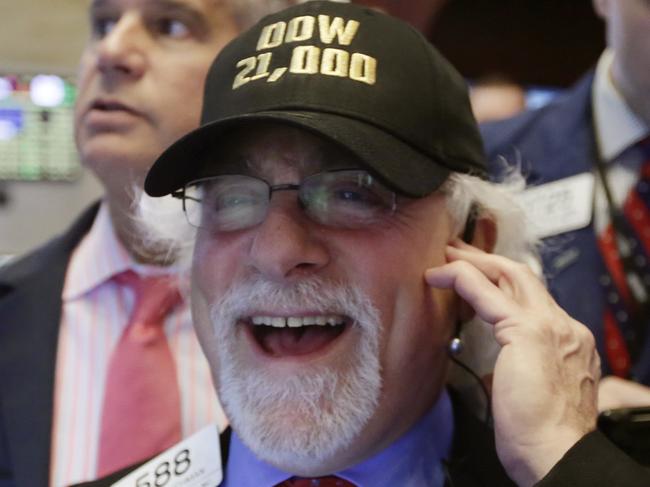 Trader Peter Tuchman wears a "Dow 21,000" hat as he works on the floor of the New York Stock Exchange, Wednesday, March 1, 2017. Stocks opened strongly higher on Wall Street, led by big gains in banks as investors expected interest rates to rise. The early jump Wednesday put the Dow Jones industrial average above 21,000 points for the first time. (AP Photo/Richard Drew)