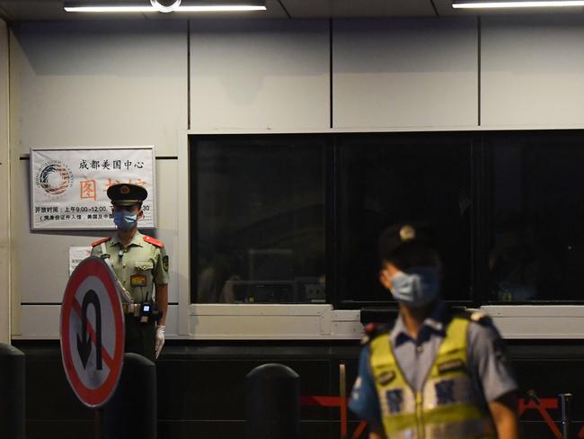 Police stand guard at the entrance to the US consulate in Chengdu. Picture: AFP