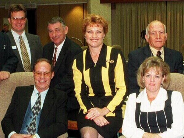 Party leader Pauline Hanson (C) with new One Nation MPs, (L-R) Ken Turner (kneeling), Jack Paff, Jeff Knuth, David Dalgleish, Charles (Charlie) Rappolt (seated), Harry Black, John Kingston, Dorothy Pratt (seated), Bill Feldman, Peter Prenzler (seated) and Shaun Nelson at Queensland State Parliament House in Brisbane.