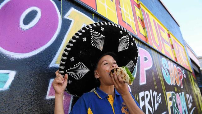 POP UP TACOS: Jayden Morris, 9, enjoys a taco at the pop-up Taco Love Bros shop in Lismore. Picture: Marc Stapelberg