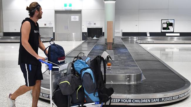 A man is seen walking past an empty baggage carousel at the Brisbane domestic airport terminal on Monday. Picture: AAP