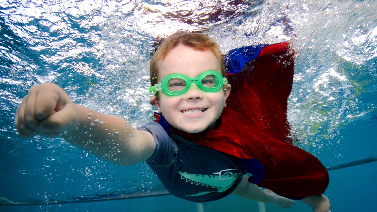 Kids smile for the underwater camera | Daily Telegraph