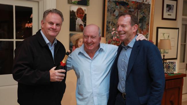 Alan Jones is congratulated by former PM Tony Abbott, right, and Mark Latham after finishing his show on his last day as a radio broadcaster at 2GB. Picture: John Feder