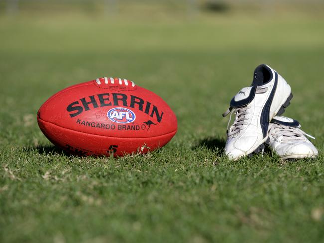 Generic AFL Sherrin football and football boots. sport /