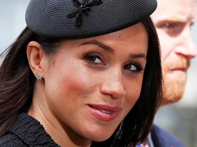 (FILES) In this file photo taken on April 25, 2018 Britain's Prince Harry (R) and his US fiancee Meghan Markle arrive to attend a service of commemoration and thanksgiving to mark Anzac Day in Westminster Abbey in London on April 25, 2018. - Meghan Markle has revealed she suffered a miscarriage in July this year, writing in the New York Times on November 25, 2020 of the deep grief and loss she endured with her husband Prince Harry. (Photo by Adrian DENNIS / AFP)