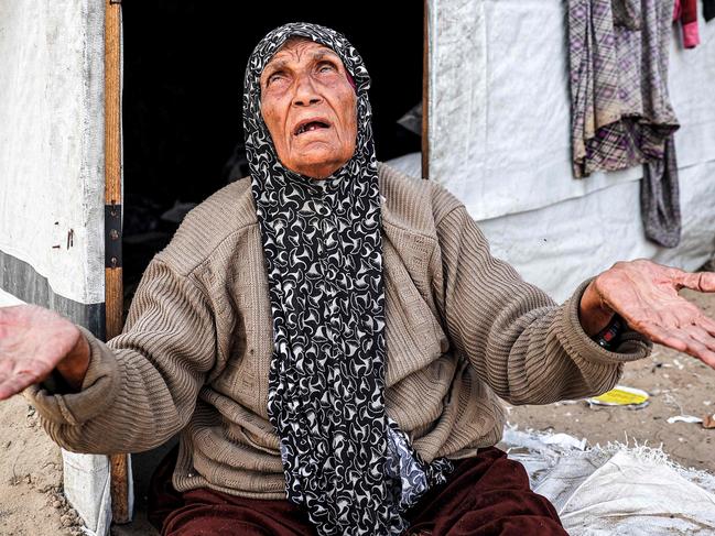 An elderly woman reacts as she sits outside a tent at a camp for displaced Palestinians in Rafah in the southern Gaza Strip. Picture: AFP