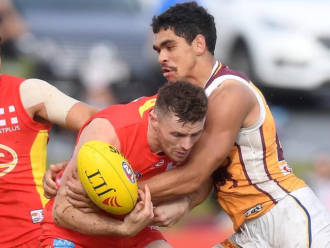 BRISBANE, AUSTRALIA - MARCH 11:  Pearce Hanley of the Suns is pressured by the defence of Charlie Cameron of the Lions during the JLT Community Series AFL match between the Gold Coast Suns and the Brisbane Lions at Fankhauser Reserve on March 11, 2018 in Brisbane, Australia.  (Photo by Bradley Kanaris/Getty Images)