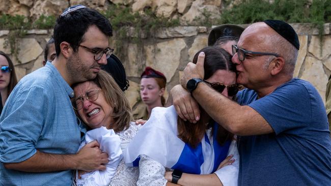 The family of Valentin (Eli) Ghnassia, 23, who was killed in a battle with Hamas militants at Kibbutz Be’eri react during his funeral. Picture: Getty