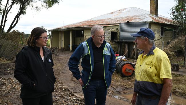 Australian Prime Minister Anthony Albanese meets with dairy farmer Milton Johnston (right) and Minister for Emergency Management Kristy McBain (left) on his property. Picture: Dean Lewins