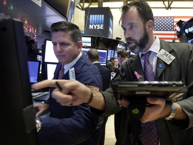 Specialist Todd Abrahal, left, and trader Thomas Cicciari work on the floor of the New York Stock Exchange, Tuesday, Dec. 15, 2015. Stocks are climbing in early trading as buyers return to a market that has been mostly beaten down in recent days. (AP Photo/Richard Drew)