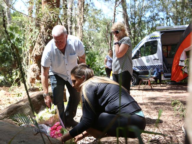 The Leveson family place flowers at the site after the search was terminated. Picture: Bob Barker