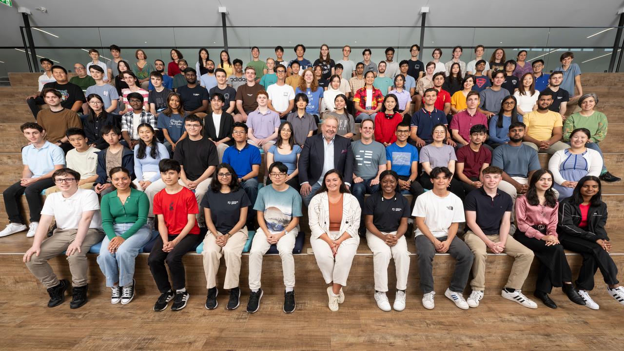 Richard White, centre, with Earn &amp; Learn program graduates. The program pays students the equivalent of $300,000 while studying and working at WiseTech.