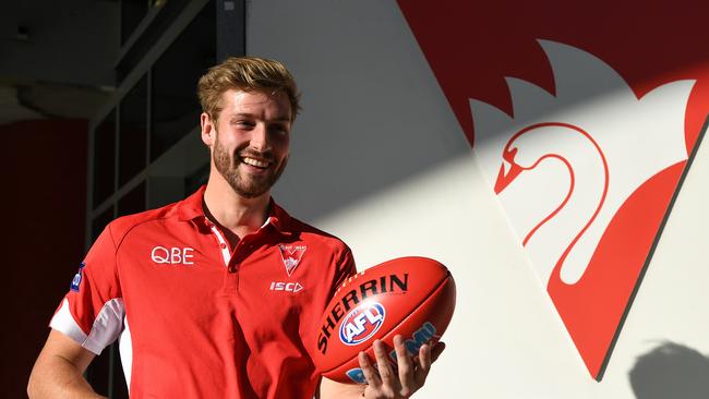 Alex Johnson is all smiles at the announcement of his return to AFL footy. Picture: AAP