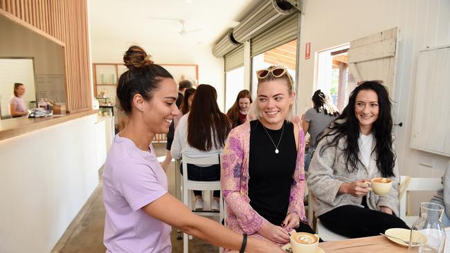 Common Ground barista Dominique Cook with patrons Allie Hunter and Melanie Bean. Picture: Lawrence Pinder