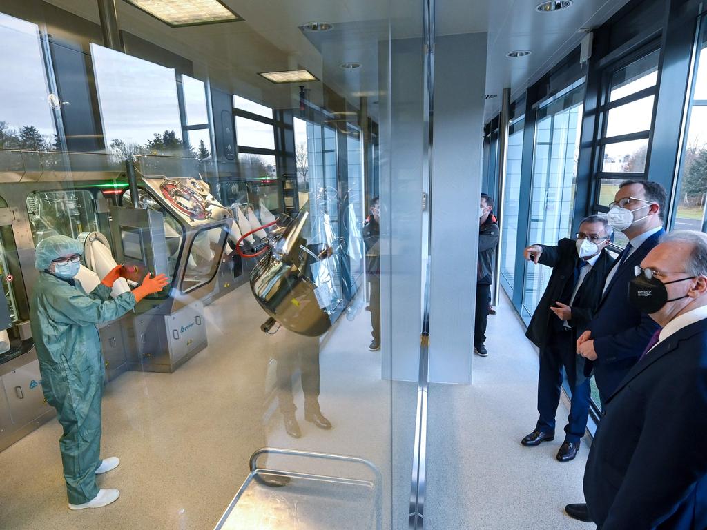 German Health Minister Jens Spahn (C) and Saxony-Anhalt's State Premier Reiner Haseloff (R), are shown around vaccine production company IDT Biologika. Picture: AFP