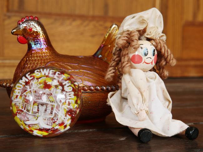 A replica brass chicken, glass dome ornament and Peg Doll of the type P.L Travers had in her study while writing Mary Poppins.