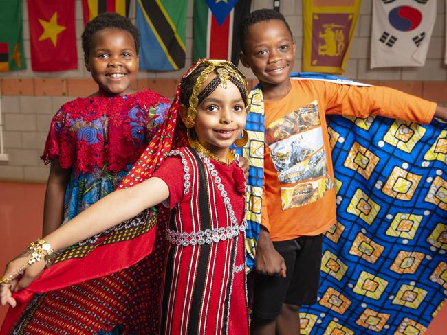 Representing their culture are (from left) Faith Bahati, Chum Ibrahim and Dieume Antoine at Harmony Day celebrations at Darling Heights State School. Picture: Kevin Farmer