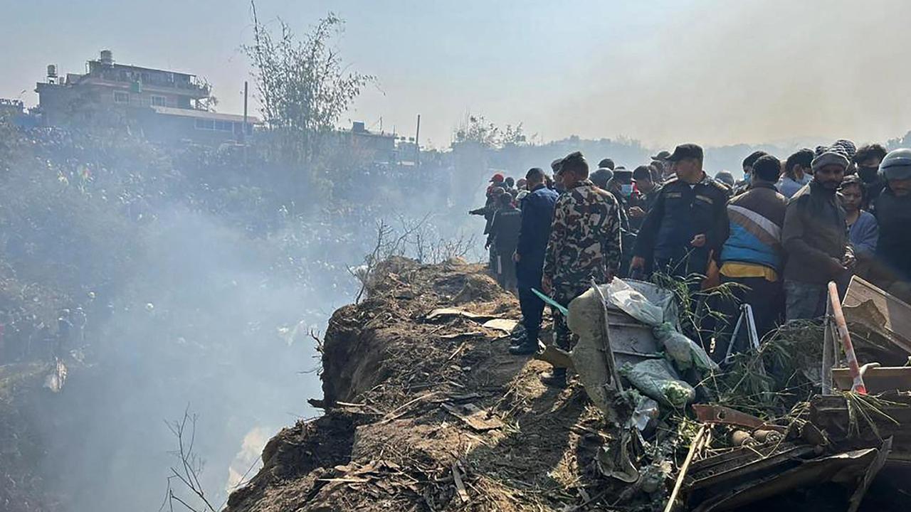 Rescuers and onlookers gather at the site of a plane crash in Pokhara. Picture: Krishna Mani Baral/AFP