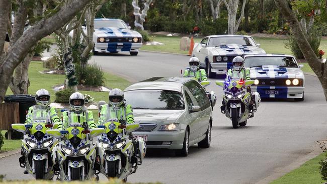 Police lead Alan Dare’s hearse into Centenary Memorial Gardens, with his family in a fleet of Ford Cobra vehicles travelling behind. Picture: NCA NewsWire / Sarah Marshall